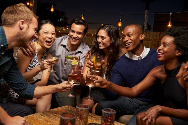 Group-Of-Friends-Enjoying-Night-Out-At-Rooftop-Bar-640x426